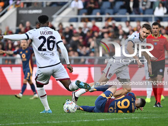 Jhon Lucumi of Bologna F.C., Stephan El Shaarawy of A.S. Roma, and Stefan Posch of Bologna F.C. are in action during the 12th day of the Ser...