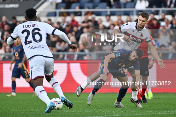 Jhon Lucumi of Bologna F.C., Stephan El Shaarawy of A.S. Roma, and Stefan Posch of Bologna F.C. are in action during the 12th day of the Ser...