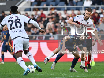 Jhon Lucumi of Bologna F.C., Stephan El Shaarawy of A.S. Roma, and Stefan Posch of Bologna F.C. are in action during the 12th day of the Ser...