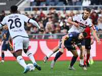 Jhon Lucumi of Bologna F.C., Stephan El Shaarawy of A.S. Roma, and Stefan Posch of Bologna F.C. are in action during the 12th day of the Ser...