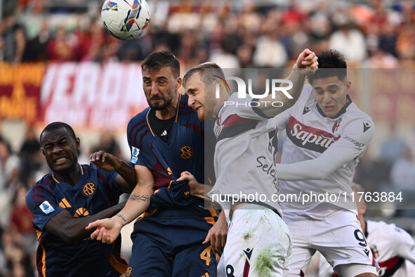 Evan Ndicka of A.S. Roma, Bryan Cristante of A.S. Roma, Remo Freuler of Bologna F.C., and Santiago Castro of Bologna F.C. are in action duri...