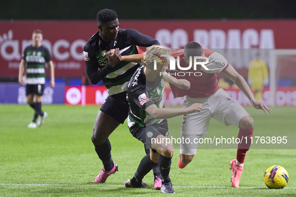 Ousmane Diomande (L) and Morten Hjulmand (C) of Sporting CP compete for the ball with Amine El Ouazzani of SC Braga during the Liga Portugal...