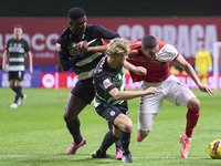 Ousmane Diomande (L) and Morten Hjulmand (C) of Sporting CP compete for the ball with Amine El Ouazzani of SC Braga during the Liga Portugal...