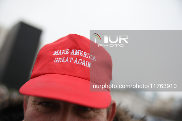 In Warsaw, Poland, on November 10, 2024, a man wearing a red 'Make America Great Again' cap supports the PiS party during the monthly celebr...