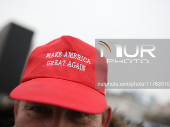 In Warsaw, Poland, on November 10, 2024, a man wearing a red 'Make America Great Again' cap supports the PiS party during the monthly celebr...