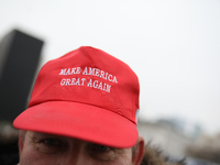 In Warsaw, Poland, on November 10, 2024, a man wearing a red 'Make America Great Again' cap supports the PiS party during the monthly celebr...