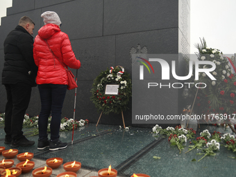 In Warsaw, Poland, on November 10, 2024, Zbigniew Komosa and his wife lay a wreath during the monthly celebrations of the Smolensk disaster...