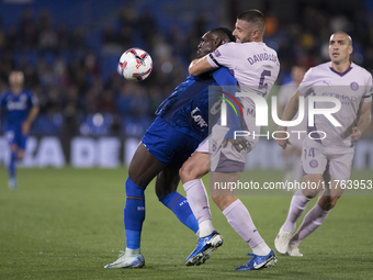 In Madrid, Spain, on November 10, Christantus Uche of Getafe and David Lopez of Girona fight for the ball during the La Liga 2024/25 match b...