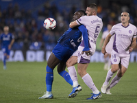 In Madrid, Spain, on November 10, Christantus Uche of Getafe and David Lopez of Girona fight for the ball during the La Liga 2024/25 match b...