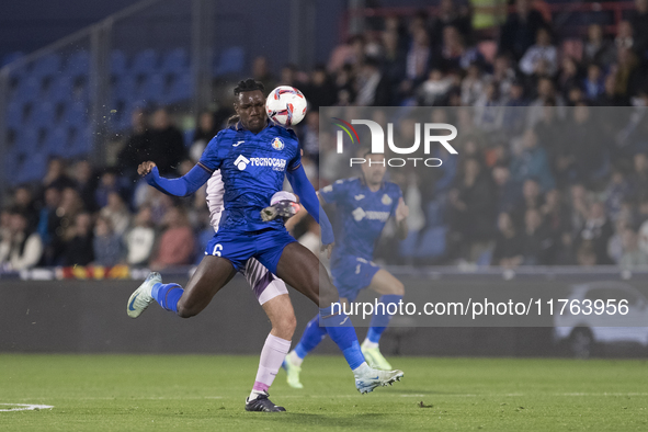 In Madrid, Spain, on November 10, Christantus Uche of Getafe and Arnau Martinez of Girona fight for the ball during the La Liga 2024/25 matc...