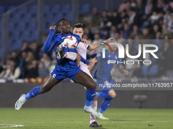 In Madrid, Spain, on November 10, Domingos Duarte of Getafe and Arnau Martinez of Girona fight for the ball during the La Liga 2024/25 match...