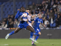 In Madrid, Spain, on November 10, Domingos Duarte of Getafe and Arnau Martinez of Girona fight for the ball during the La Liga 2024/25 match...