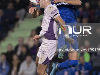 In Madrid, Spain, on November 10, Domingos Duarte of Getafe and Arnau Martinez of Girona fight for the ball during the La Liga 2024/25 match...