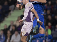 In Madrid, Spain, on November 10, Domingos Duarte of Getafe and Arnau Martinez of Girona fight for the ball during the La Liga 2024/25 match...