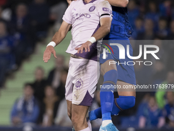 In Madrid, Spain, on November 10, Domingos Duarte of Getafe and Arnau Martinez of Girona fight for the ball during the La Liga 2024/25 match...