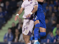 In Madrid, Spain, on November 10, Domingos Duarte of Getafe and Arnau Martinez of Girona fight for the ball during the La Liga 2024/25 match...