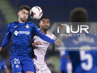 In Madrid, Spain, on November 10, Yellu Santiago of Getafe and Yangel Herrera of Girona fight for the ball during the La Liga 2024/25 match...