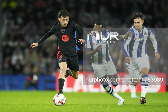 Pedri central midfield of Barcelona and Spain and Sheraldo Becker centre-forward of Real Sociedad and Netherlands compete for the ball durin...