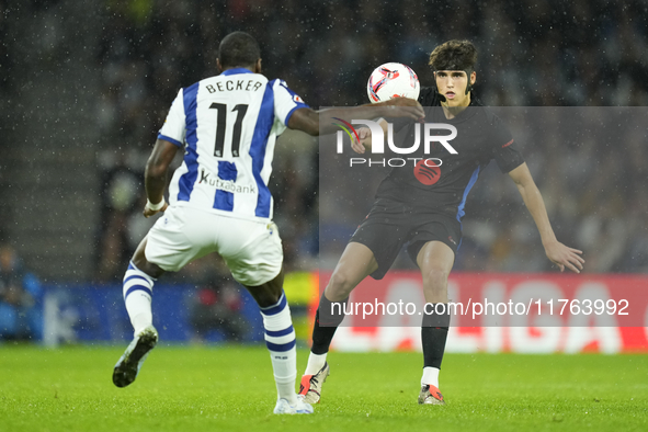 Pau Cubarsi centre-back of Barcelona and Spain and Sheraldo Becker centre-forward of Real Sociedad and Netherlands compete for the ball duri...