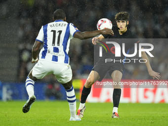 Pau Cubarsi centre-back of Barcelona and Spain and Sheraldo Becker centre-forward of Real Sociedad and Netherlands compete for the ball duri...