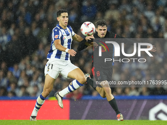 Pedri central midfield of Barcelona and Spain and Nayef Aguerd centre-back of Real Sociedad and Morocco during the LaLiga match between Real...