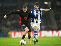 Fermin Lopez central midfield of Barcelona and Spain and Aihen Munoz left-back of Real Sociedad and Spain compete for the ball during the La...