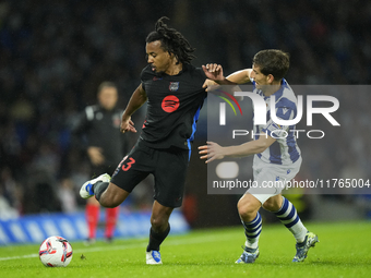 Jules Kounde centre-back of Barcelona and France and Aihen Munoz left-back of Real Sociedad and Spain compete for the ball during the LaLiga...