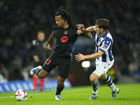 Jules Kounde centre-back of Barcelona and France and Aihen Munoz left-back of Real Sociedad and Spain compete for the ball during the LaLiga...