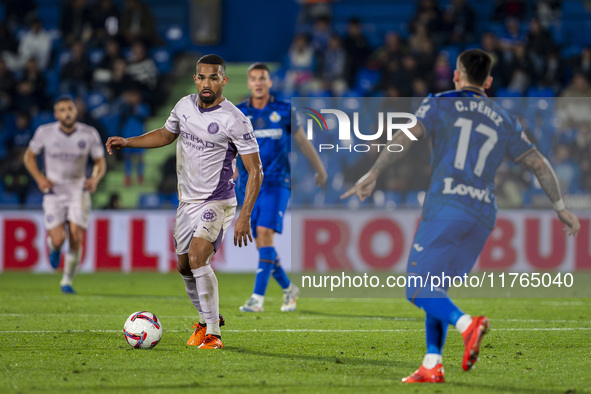 Yangel Herrera of Girona FC (left) is in action against Carles Perez of Getafe CF (right) during the La Liga EA Sports 2024/25 football matc...