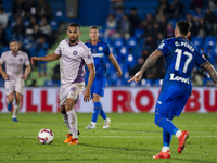 Yangel Herrera of Girona FC (left) is in action against Carles Perez of Getafe CF (right) during the La Liga EA Sports 2024/25 football matc...