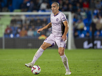 Oriol Romeu of Girona FC is in action with the ball during the La Liga EA Sports 2024/25 football match between Getafe CF and Girona FC at E...