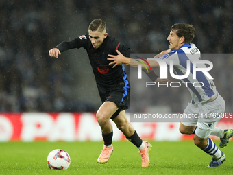 Fermin Lopez central midfield of Barcelona and Spain and Aihen Munoz left-back of Real Sociedad and Spain  aaco during the LaLiga match betw...