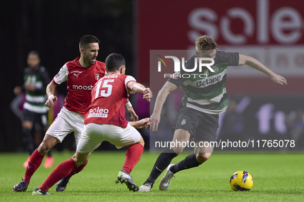 Joao Moutinho and Paulo Oliveira of SC Braga compete for the ball with Viktor Gyokeres of Sporting CP during the Liga Portugal Betclic match...