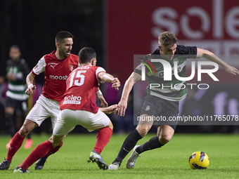 Joao Moutinho and Paulo Oliveira of SC Braga compete for the ball with Viktor Gyokeres of Sporting CP during the Liga Portugal Betclic match...