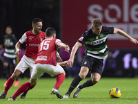 Joao Moutinho and Paulo Oliveira of SC Braga compete for the ball with Viktor Gyokeres of Sporting CP during the Liga Portugal Betclic match...