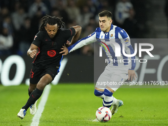 Jules Kounde centre-back of Barcelona and France and Ander Barrenetxea left winger of Real Sociedad and Spain compete for the ball during th...