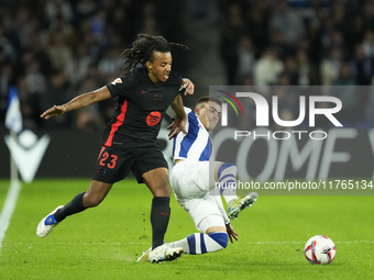 Jules Kounde centre-back of Barcelona and France and Ander Barrenetxea left winger of Real Sociedad and Spain compete for the ball during th...