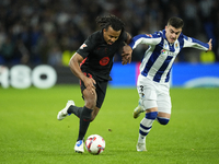 Jules Kounde centre-back of Barcelona and France and Ander Barrenetxea left winger of Real Sociedad and Spain compete for the ball during th...