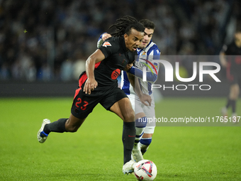 Jules Kounde centre-back of Barcelona and France and Ander Barrenetxea left winger of Real Sociedad and Spain compete for the ball during th...