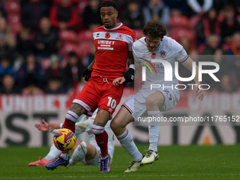 Delano Burgzorg of Middlesbrough battles with Tom Holmes of Luton Town during the Sky Bet Championship match between Middlesbrough and Luton...