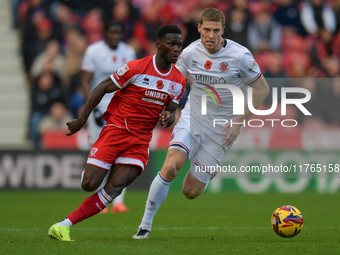 Middlesbrough's Emmanuel Latte Lath runs with Luton Town's Mark McGuinness chasing him during the Sky Bet Championship match between Middles...