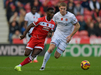 Middlesbrough's Emmanuel Latte Lath runs with Luton Town's Mark McGuinness chasing him during the Sky Bet Championship match between Middles...