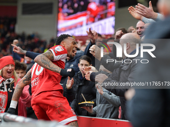 Delano Burgzorg of Middlesbrough leaps the barriers after opening the scoring for Middlesbrough to celebrate with the fans during the Sky Be...