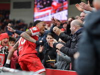 Delano Burgzorg of Middlesbrough leaps the barriers after opening the scoring for Middlesbrough to celebrate with the fans during the Sky Be...