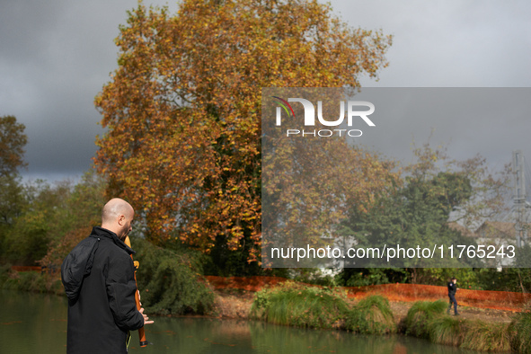 A resident plays music to support the 'ecureuils' living in the plane tree on the other bank of the Canal du Midi. The gendarmerie blocks ac...