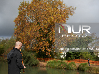 A resident plays music to support the 'ecureuils' living in the plane tree on the other bank of the Canal du Midi. The gendarmerie blocks ac...