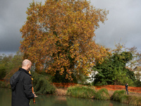 A resident plays music to support the 'ecureuils' living in the plane tree on the other bank of the Canal du Midi. The gendarmerie blocks ac...