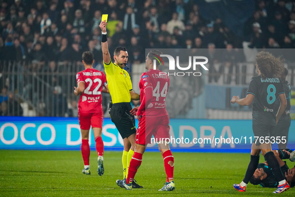 Andrea Colombo, the referee, shows the yellow card to Andrea Carboni during the match between AC Monza and SS Lazio in Serie A at U-Power St...