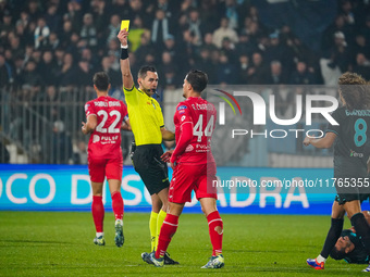 Andrea Colombo, the referee, shows the yellow card to Andrea Carboni during the match between AC Monza and SS Lazio in Serie A at U-Power St...