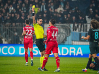 Andrea Colombo, the referee, shows the yellow card to Andrea Carboni during the match between AC Monza and SS Lazio in Serie A at U-Power St...